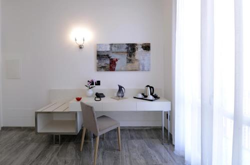 a white desk with a chair and a table at Best Western Hotel Principe di Lampedusa in Palermo