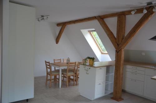 a kitchen and dining room with a table and a window at Nocleharna na stodole in Žďárky