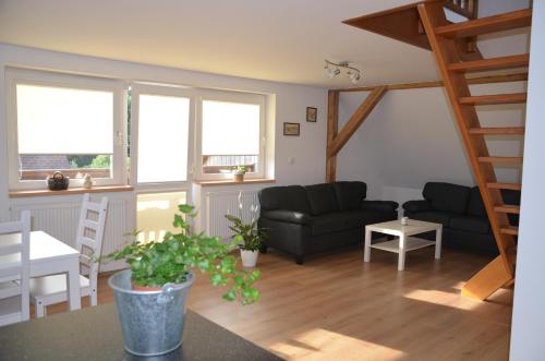 a living room with a couch and a table at Nocleharna na stodole in Žďárky
