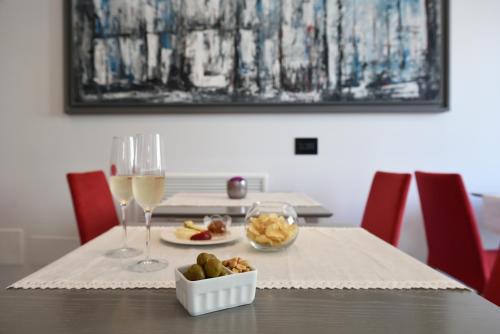 a table with a plate of food and a glass of wine at Best Western Hotel Principe di Lampedusa in Palermo