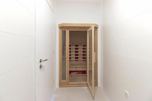 a small closet in a white room with a glass door at Villa Median in Žman