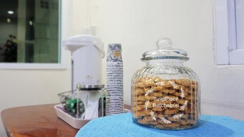 a glass jar filled with nuts on top of a table at Tulip Place in Ratchaburi