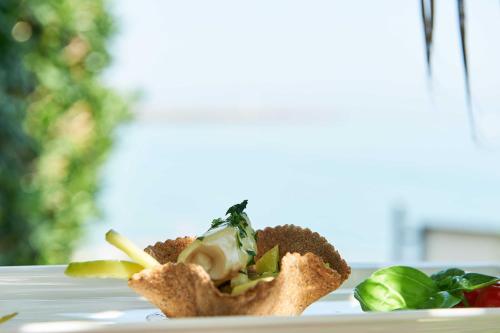 a dish of food on a white plate at Hotel Croce Di Malta in Imperia