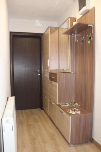 a kitchen with wooden cabinets and a door at Vuk Popovic in Žabljak