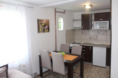 a kitchen and dining room with a table and chairs at Vuk Popovic in Žabljak