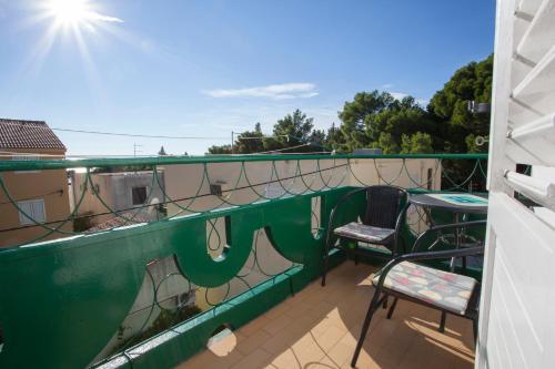 a balcony with two chairs and a table on it at The best location in Makarska,free P, option bikes in Makarska