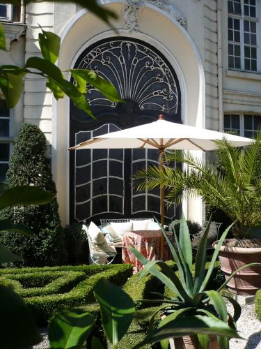 a patio with an umbrella in front of a building at B&B The Verhaegen in Ghent