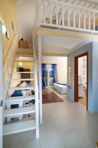 a room with a bunk bed and a staircase at Caretta Village in Toroni
