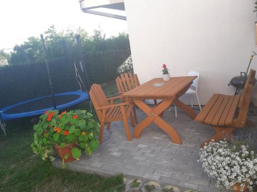 a patio with a wooden table and two chairs at Sjesta in Jastrzębia Góra