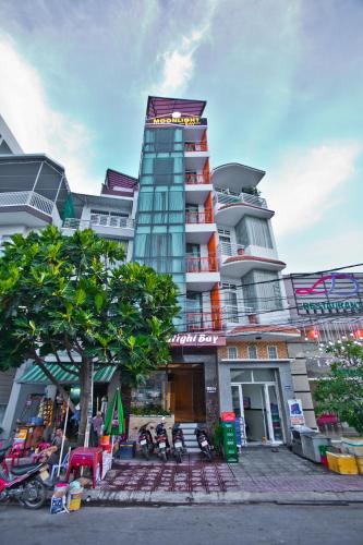 a tall building with a sign on top of it at Moonlight Bay Hotel & Apartment in Nha Trang