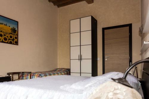 a bedroom with a bed and a closet and a door at Sunflower in Palaia
