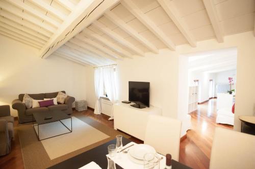 a living room with a couch and a tv at Italianflat - Palazzo Zeiner in Verona