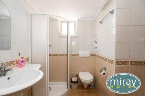 a bathroom with a sink and a toilet and a shower at Miray Hotel in Marmaris