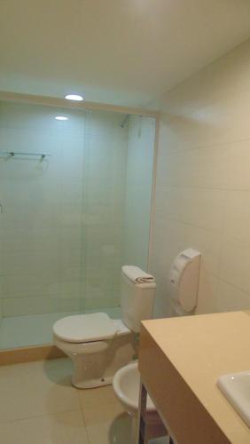 a bathroom with a toilet and a glass shower at Mirasol Copacabana Hotel in Rio de Janeiro