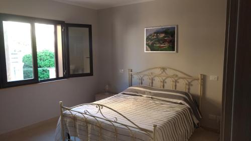 a bedroom with a bed and a window in it at B&B PARADISE in Villa San Giovanni