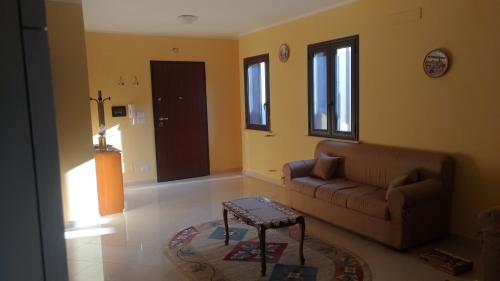 a living room with a couch and a table at B&B PARADISE in Villa San Giovanni