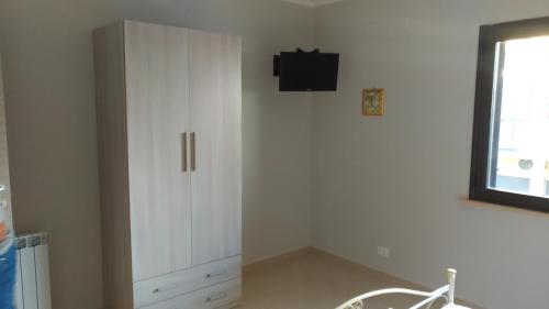 a white cabinet in a room with a window at B&B PARADISE in Villa San Giovanni