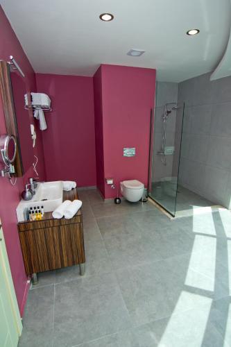 a bathroom with a sink and a shower at King Sky Tower Hotel in Batumi