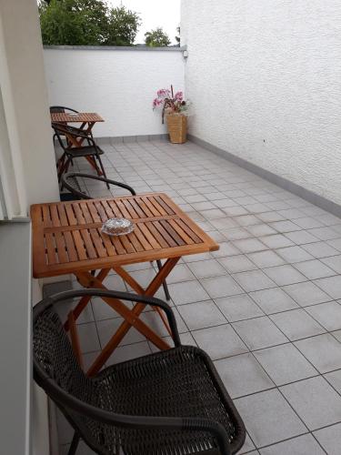 a wooden table and chairs on a patio at Hotel Elsenztal in Bammental