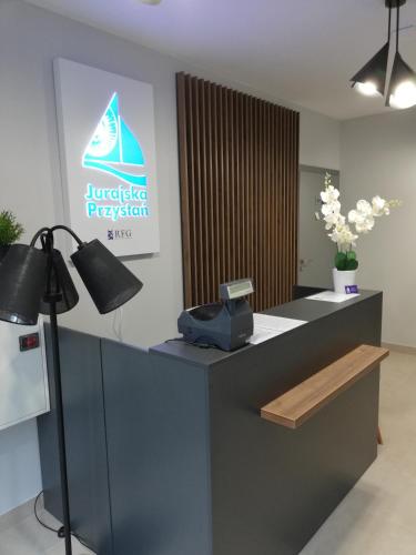 a reception desk with a phone on top of it at Jurajska Przystań in Jastrząb