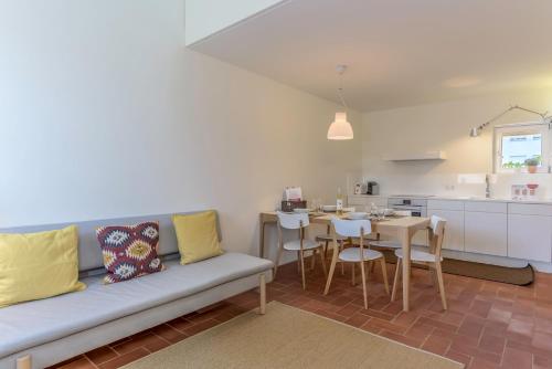 a living room with a couch and a table at Convento das Bernardas Charming - Tavira in Tavira