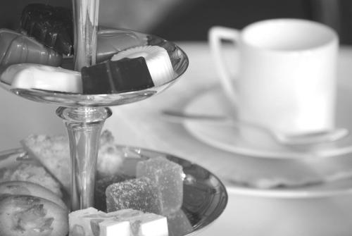 a plate of sugar and a cup of coffee on a table at Hotel Geerts in Westerlo