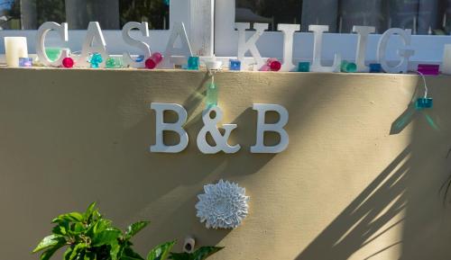 a sign on a wall with a baby name and a toy at Casa Kilig in Santa Cruz de Tenerife