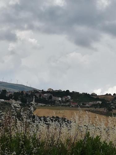 a sandy beach with houses in the distance and a beach at B&B Belvedere in Castelluccio Valmaggiore