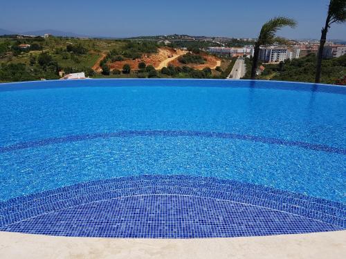 a large blue swimming pool with a view at Casa D'Olga in Lagos