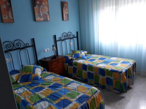 a bedroom with two beds and a window at O'Corpiño in Muxia