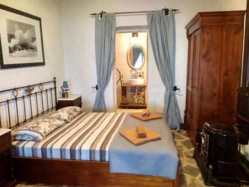 a bedroom with a bed with two towels on it at Villa Haris in Sarti