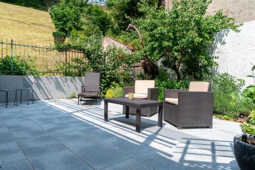 a patio with two chairs and a table and chairs at Old Town Apartments in Kaufbeuren