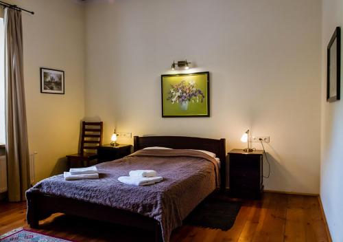 a bedroom with a bed with two towels on it at Lublin Apartaments in Lublin