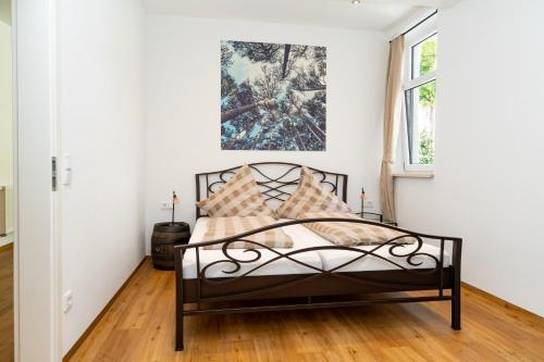 a bedroom with a black bed and a window at Old Town Apartments in Kaufbeuren