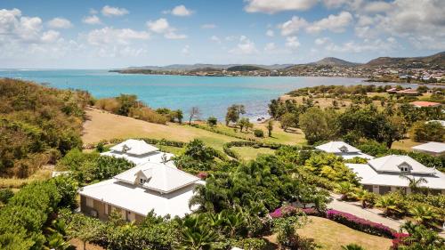 an aerial view of a resort with the ocean at Villas Palm in Le Vauclin