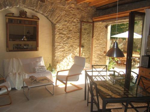 a living room with a couch and a table at Gite la Tour in Pépieux