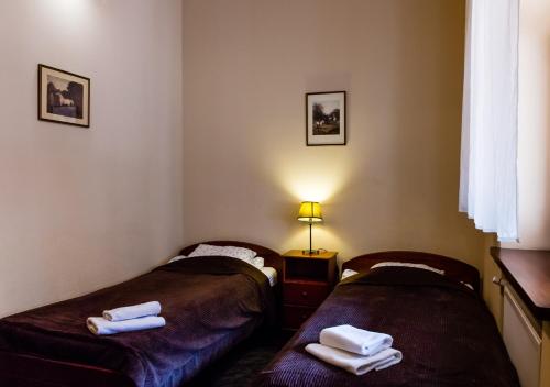 two beds in a room with towels on them at Lublin Apartaments in Lublin