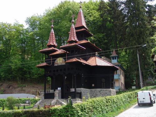 a large building with turrets on the side of a road at Hotel Hefaistos - Sovata in Sovata