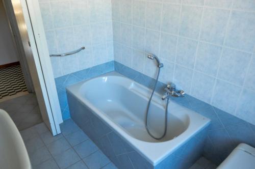 a bath tub with a shower in a bathroom at Casa Maddalena in Nocera Umbra