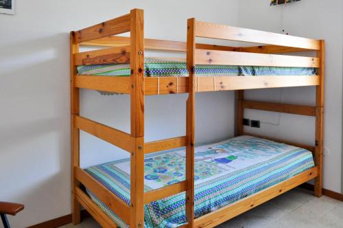 a bunk bed with a wooden bunk bed ladder at Casa Maddalena in Nocera Umbra