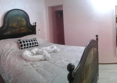 a bedroom with a bed with two towels on it at Agriturismo Nonni Devia in Lucinasco