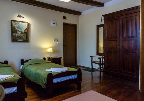 a bedroom with two beds and a wooden cabinet at Lublin Apartaments in Lublin
