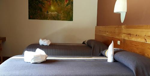 a bed with two pillows on it in a room at Axkan Arte Hotel in San Cristóbal de Las Casas