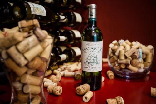 a bottle of wine sitting on a table next to a bunch of wine bottles at Hotel Mandát in Hradištko