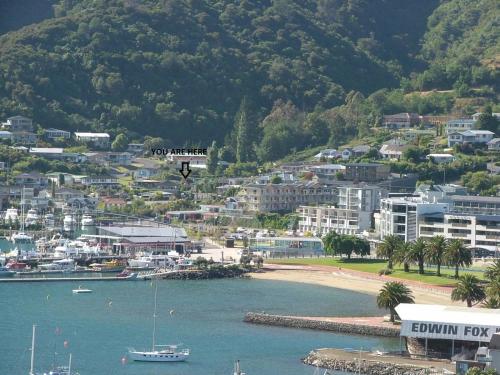 a view of a city with a boat in the water at 3 & 4 Bedroom Holiday Houses Central Picton in Picton