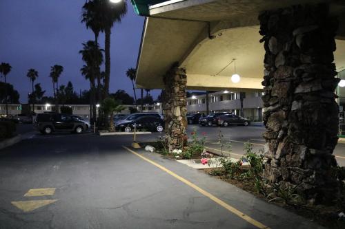 a parking lot with cars parked in a building at Valli Hi Motel in San Ysidro, San Diego