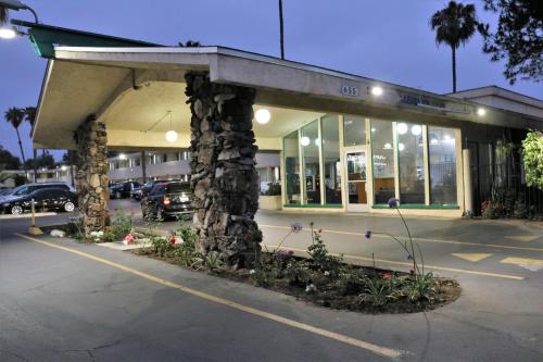 a parking lot in front of a shopping center at Valli Hi Motel in San Ysidro, San Diego