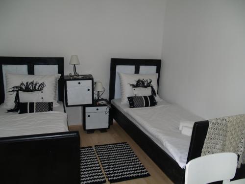 a bedroom with two beds and two night stands at Pannonia Terranova in Vardarac