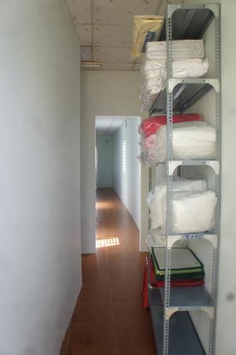 a room with a rack of towels and a hallway at BangBang Motel in Can Tho