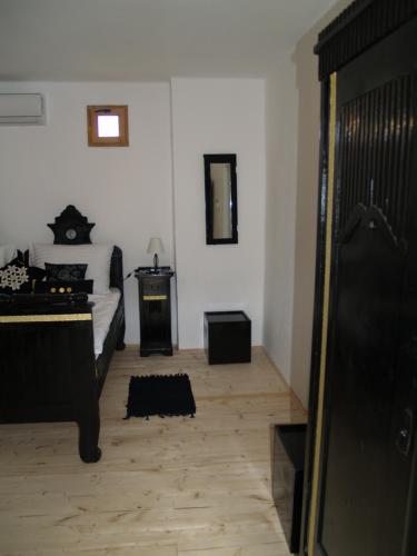 a bedroom with a bed and a mirror at Pannonia Terranova in Vardarac